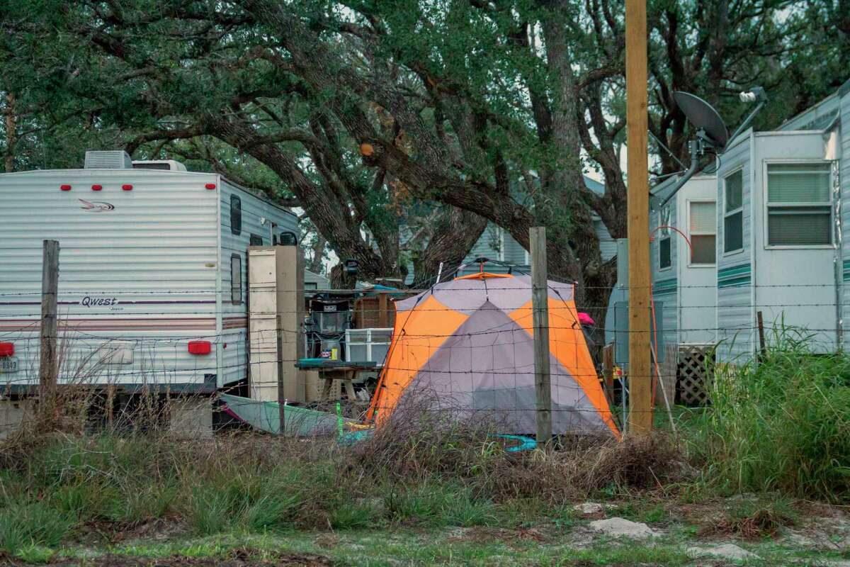 In this Dec. 15, 2017 photo provided by Kim Porter, shows people living in tents and trailers in Rockport, Texas. The federal government typically spends up to $150,000 apiece _ not counting utilities, maintenance or labor _ on the trailers it leases to disaster victims, then auctions them at cut-rate prices after 18 months of use or the first sign of minor damage. Officials have continued the practice even amid a temporary housing shortage in Texas, where almost 8,000 applicants are still awaiting federal support nearly four months after Hurricane Harvey landed in the Gulf Coast. (Kim Porter via AP)