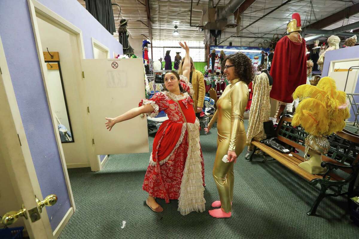 Corinne Villanueva (left) tries on a costume with friend Cassandra Morris at Frankel's Costume, an Houston institution, that closed their doors Wednesday, Dec. 27, 2017 as the owners are retiring. Everything was half-price and the owners will have a encore sale the first weekend in January.