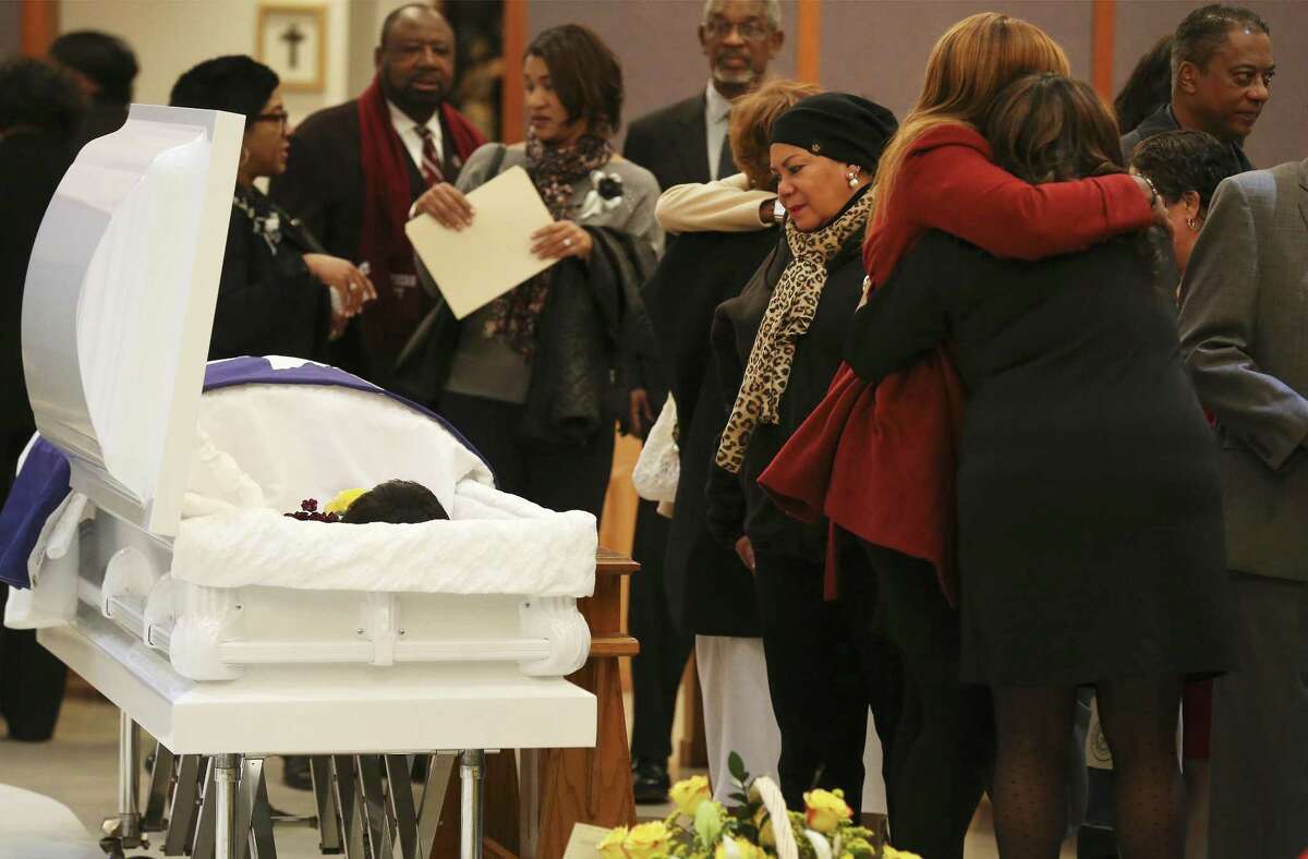 A mourner pauses in front of the open casket to pay respect during a memorial service for former state representative Ruth Jones McClendon at Holy Redeemer Catholic Church on Wednesday, Dec. 27, 2017. McClendon passed away at the age of 74 on December 19 after a long battle with stage 4 lung cancer. Family, friends and fellow legislative colleagues gathered to pay respects for McClendon who served District 120 for two decades. Funeral services will be held on Thursday. (Kin Man Hui/San Antonio Express-News)
