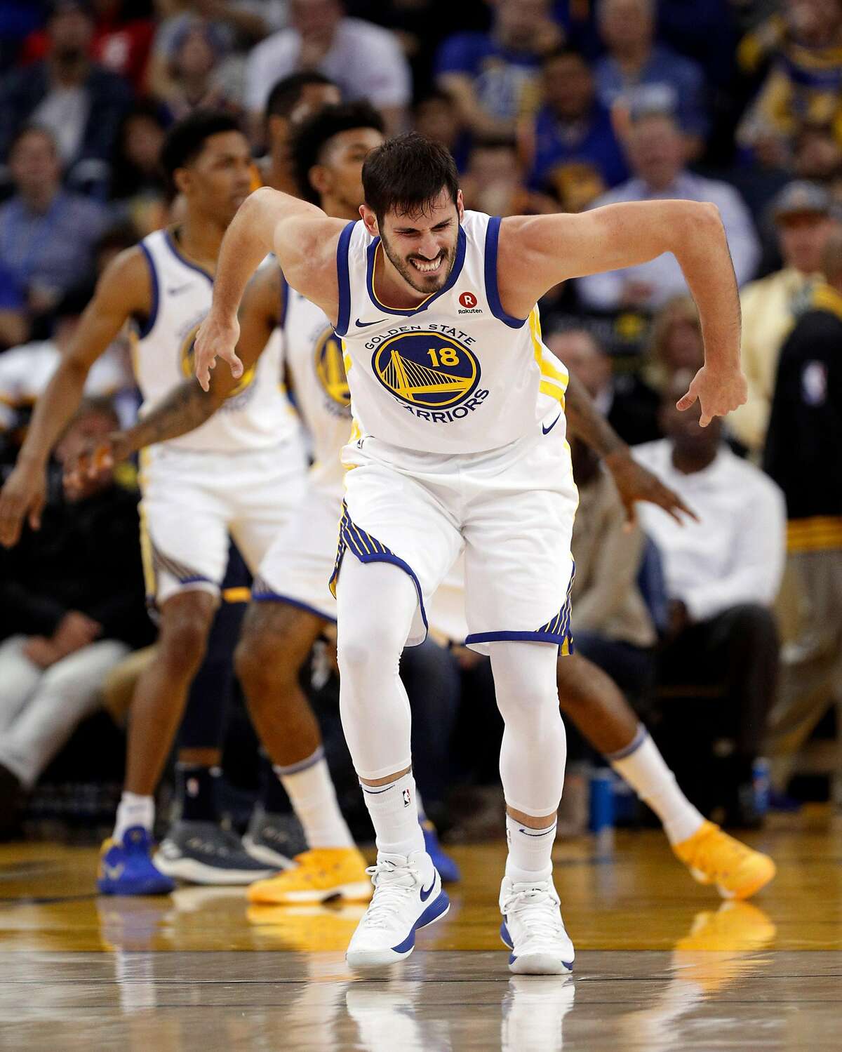 Omri Casspi (18) grimaces after injuring his ankle in the second half as the Golden State Warriors played the Utah Jazz at Oracle Arena in Oakland on Wednesday, Dec. 27, 2017.