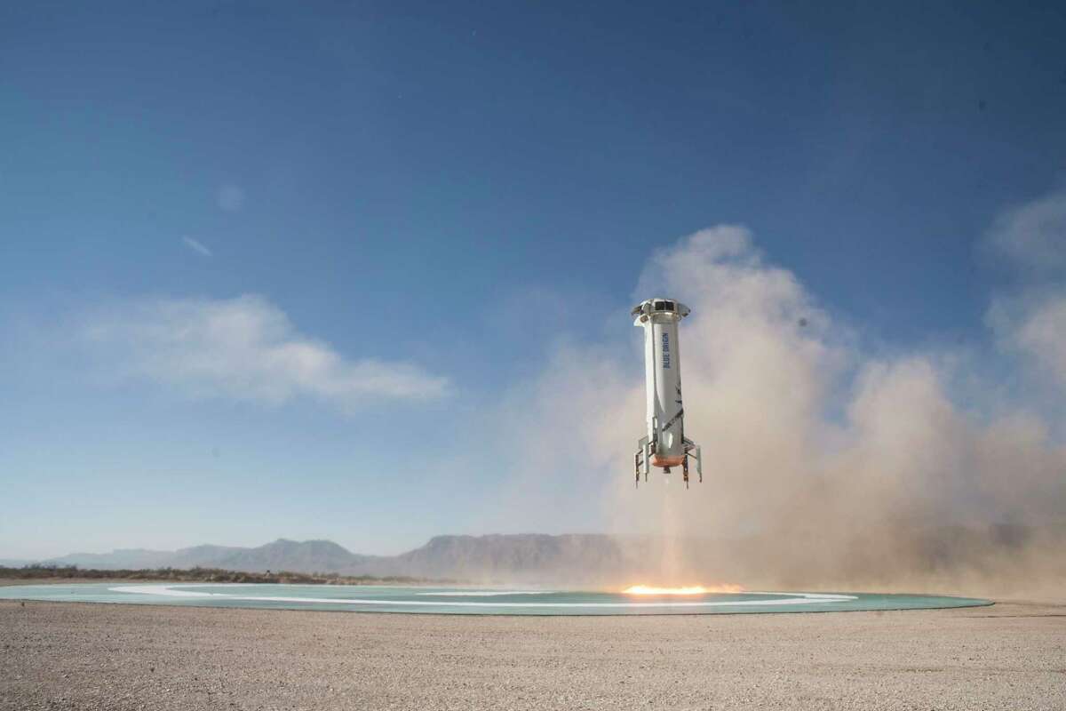 In this photo provided by Blue Origin, the New Shepard booster lands in west Texas during a test on Tuesday, Dec. 12, 2017. Named after the first American in space, Alan Shepard, the spacecraft made a 10-minute suborbital flight. (Blue Origin via AP)