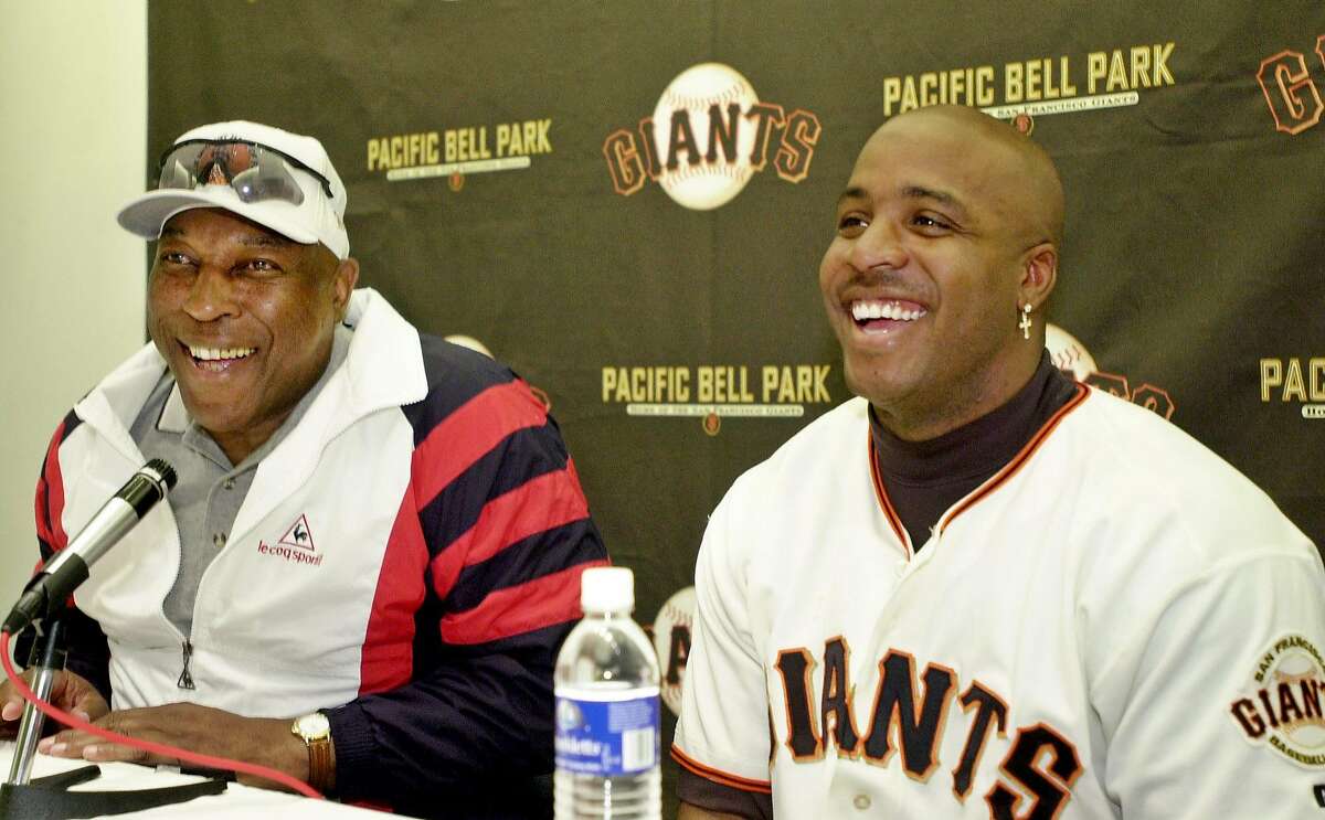 San Francisco Giants' Barry Bonds, right, smiles with Willie McCovey, left, at a news conference after the Giants' game against the Arizona Diamondbacks, Wednesday, May 30, 2001, in San Francisco. Bonds hit his 521st and 522nd to move into 11th place past McCovey and Ted Williams, who hit 521. The Diamondbacks beat the Giants 4-3. (AP Photo/Paul Sakuma)