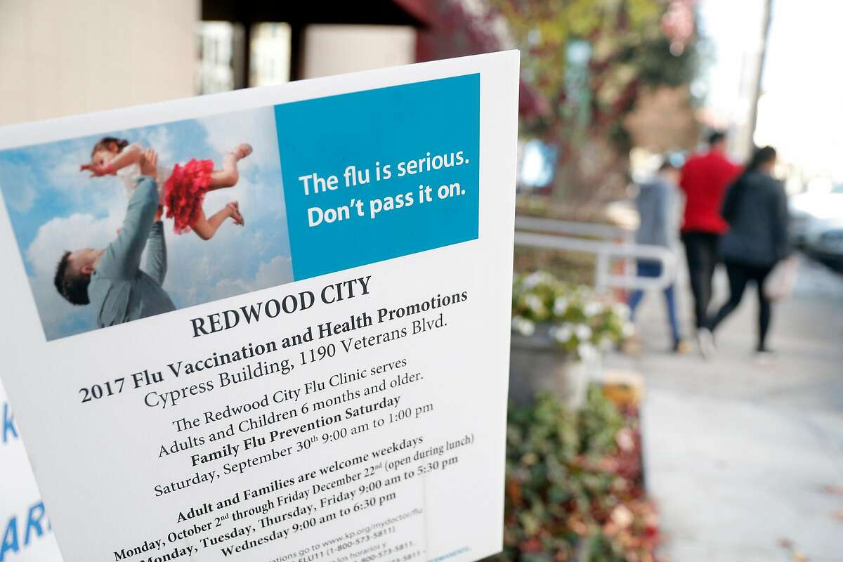 A sign encouraging getting a flu vaccine at the Kaiser Permanente Redwood City hospital in Redwood City, Calif., on Thursday, December 28, 2017.