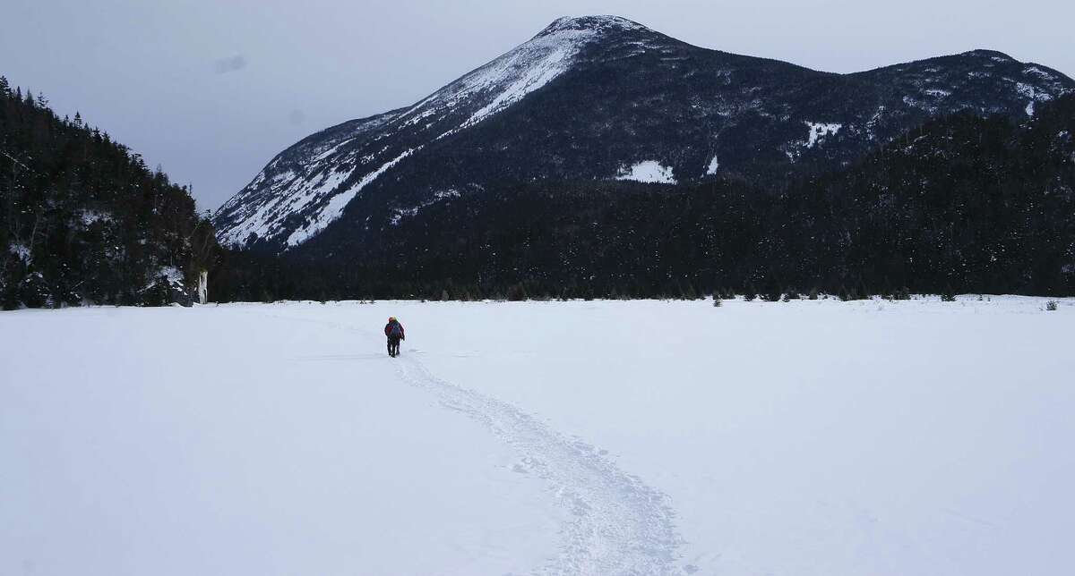 A hiker makes his way across the Flowed Lands with Mount Colden behind him in this 2015 photo. (Herb Terns / Times Union)