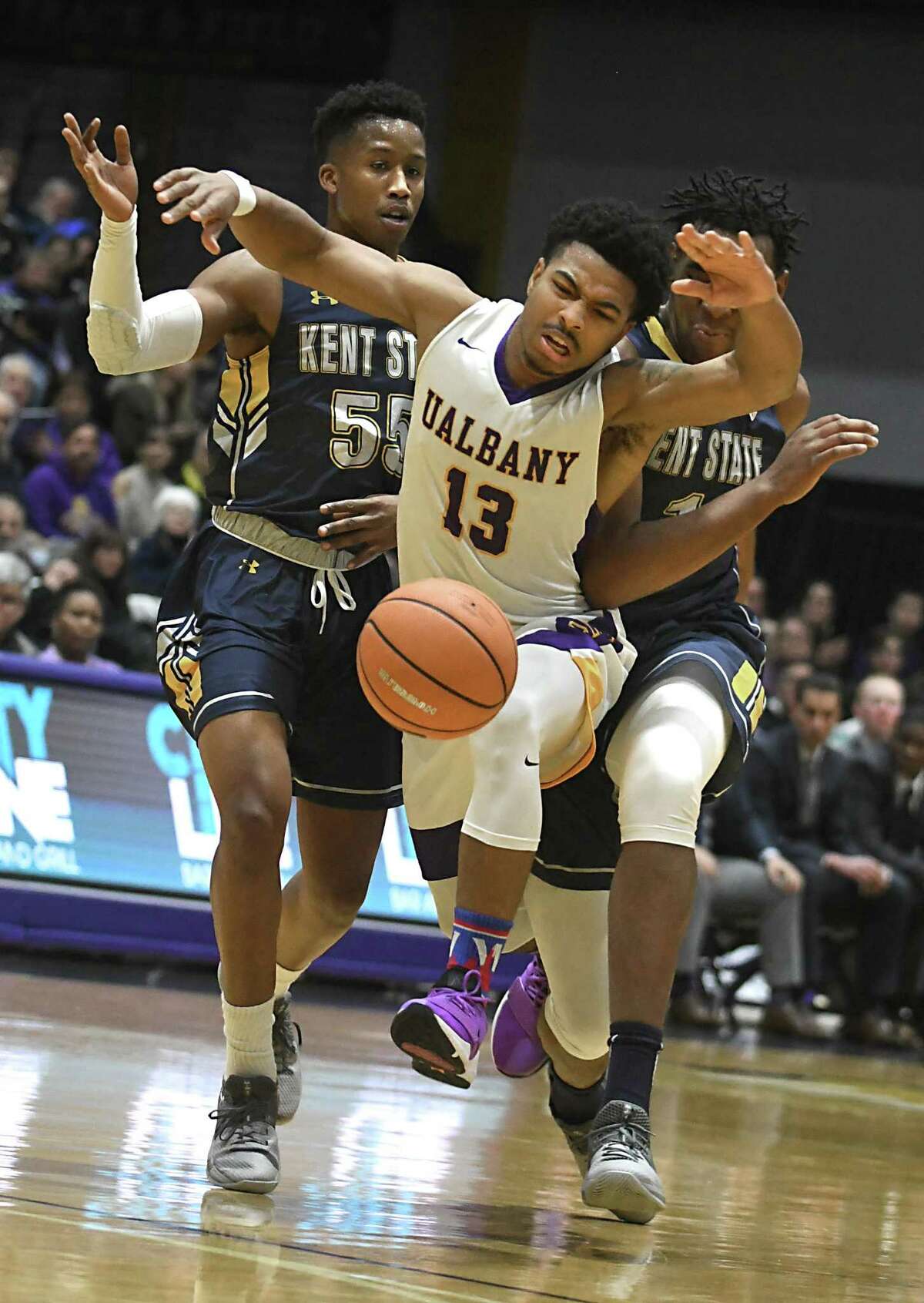 University at Albany's David Nichols loses the ball as he is guarded by Kent State's Kevin Zabo, left, and Adonis De La Rosa during a basketball game at SEFCU Arena on Thursday, Dec. 28, 2017 in Albany, N.Y. (Lori Van Buren / Times Union)