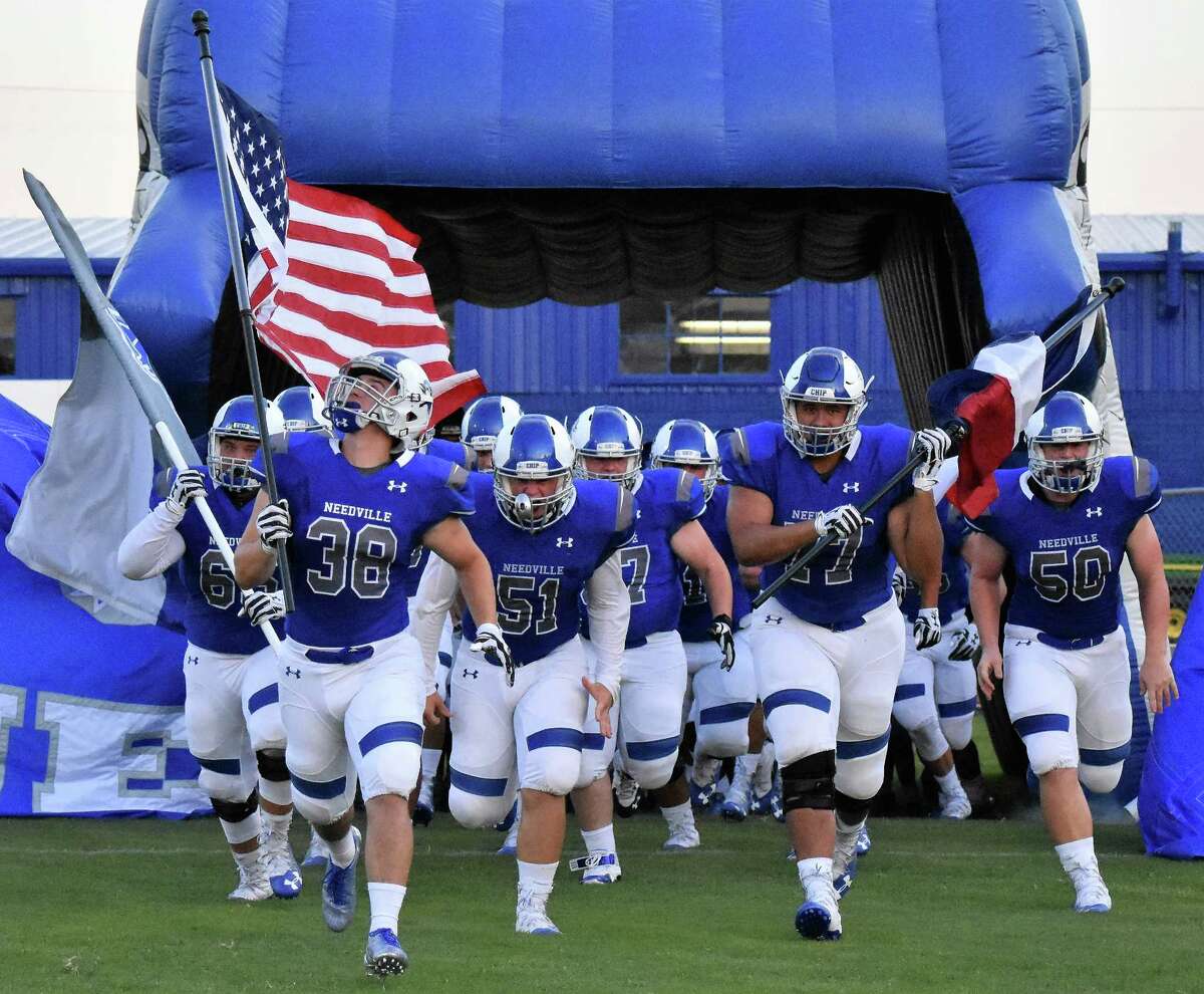 Running onto the field Friday night with their Blue Jay pride in full force, members of the Needville High School varsity football team were ready for the season to finally began. From left are Mason Pace with the Needville Blue Jays flag, Quade Miller with the American flag, Trevor Short, Cameron Harris with the Texas flag, and Trystan Short.