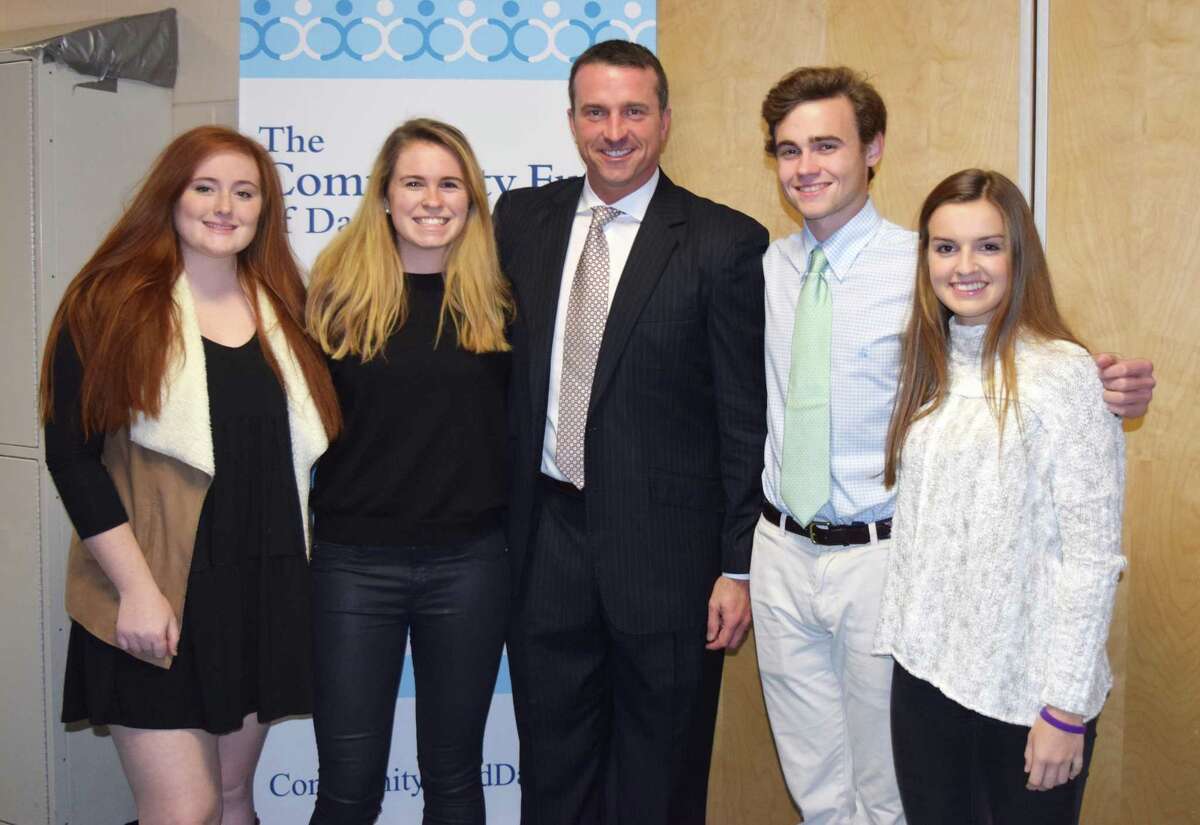 Chris Herren, a former NBA star and recovered addict who spoke at Darien High School Nov. 30, poses with Youth Asset Team Presidents Olivia Taylor, left, Emma Dahlquist, Will Harman and Sydney Schrenker.