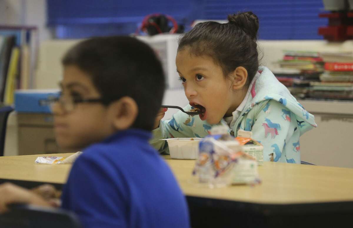 Maddie Ortega,7, eats cereal Wednesday morning December 20, 2017 in her classroom at De Zavala Elementary school on San Antonio's West Side. The San Antonio Independent School District is ranked highly statewide for its school food program, mostly due to serving breakfast in class which drives student participation rates higher.