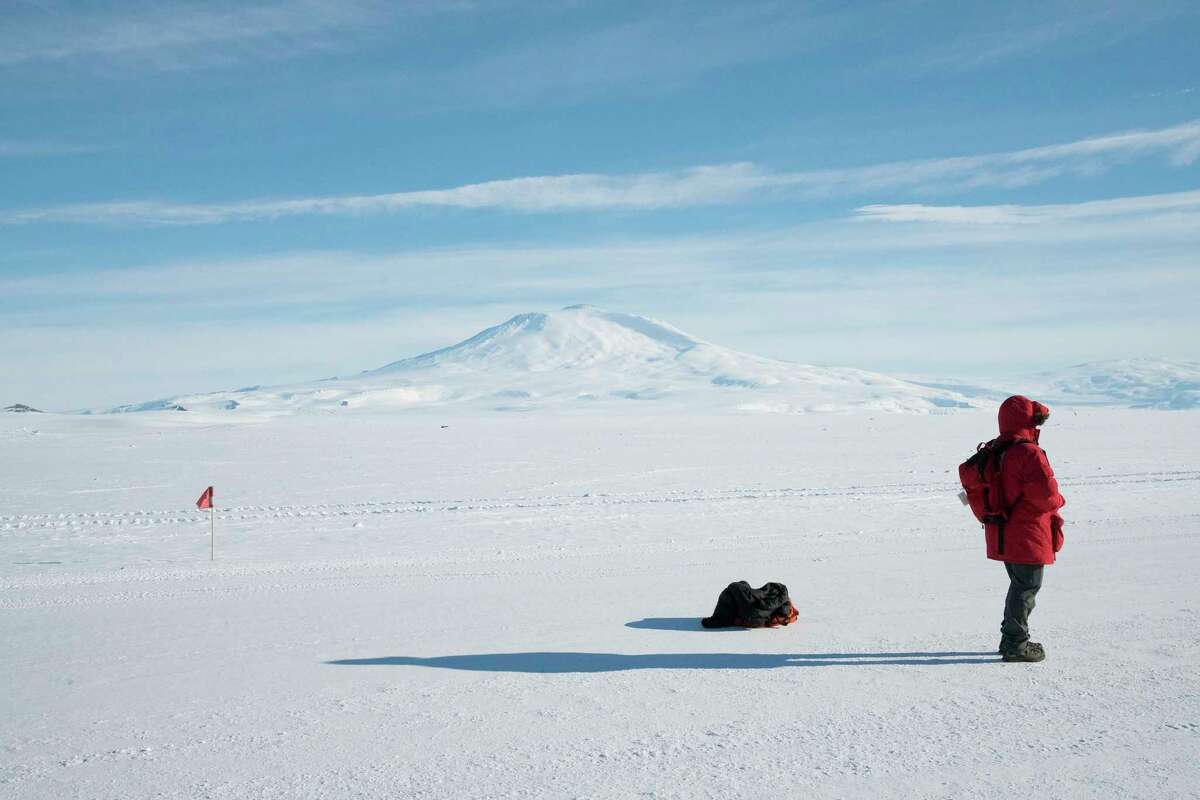 A McMurdo resident watches a NASA balloon launch while standing on the Ross Ice Shelf, with Mount Erebus in the distance, in Antarctica, November 2016. Click through the gallery to see photos of polar ice melt on antarctica. 