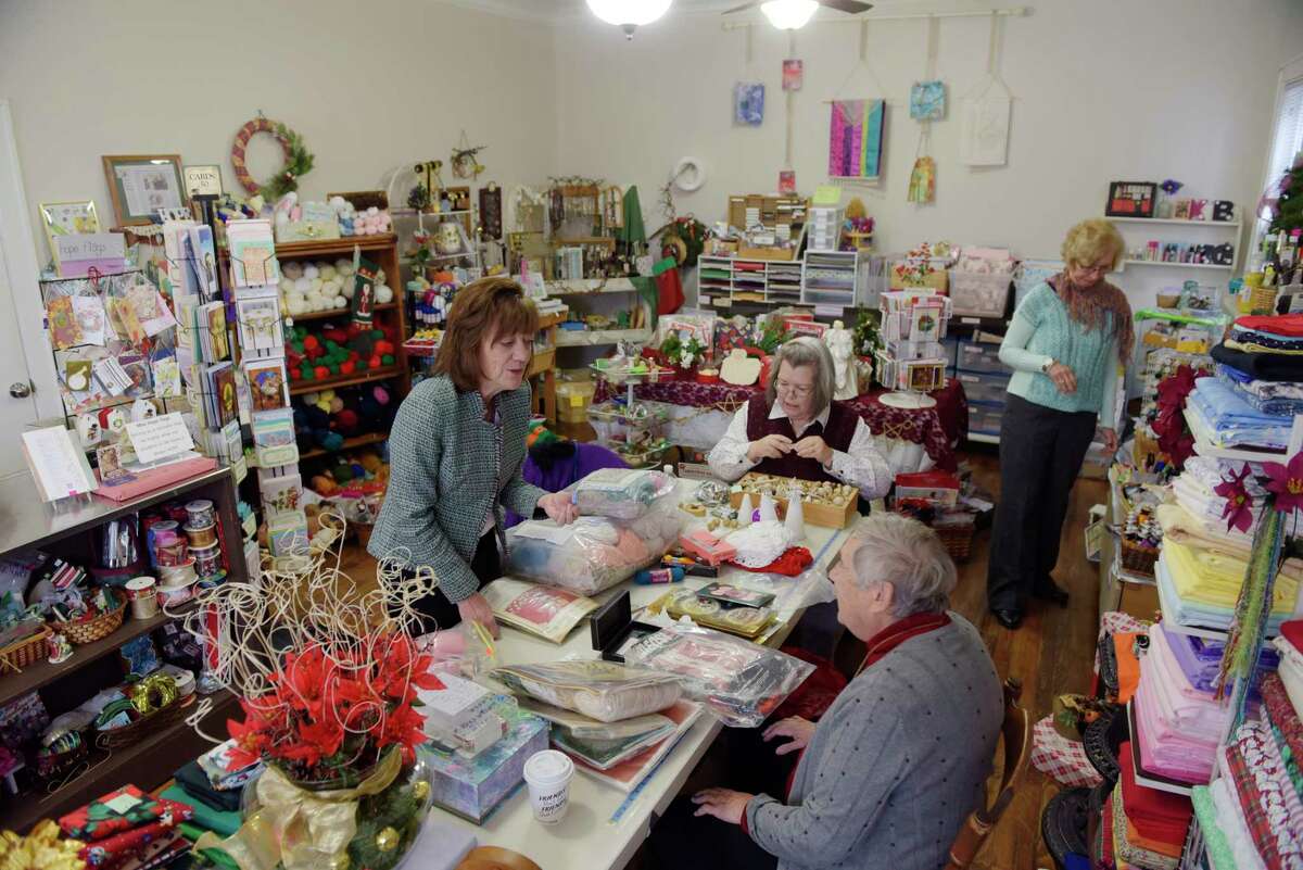 Debbie Fowler, foreground left, president of Eyes Wide Open NENY, volunteer Patricia Bush, second from left, volunteer Sister Fran Dempsey, third from left, and also a Eye Wide Open board member, and volunteer Karen Jiuzio, work in the store Her Treasure Box, on Tuesday, Nov. 14, 2017, in Schenectady, N.Y. Her Treasure Box raises funds to support Eyes Wide Open NENY, which offers services for those affected by human trafficking. (Paul Buckowski / Times Union)