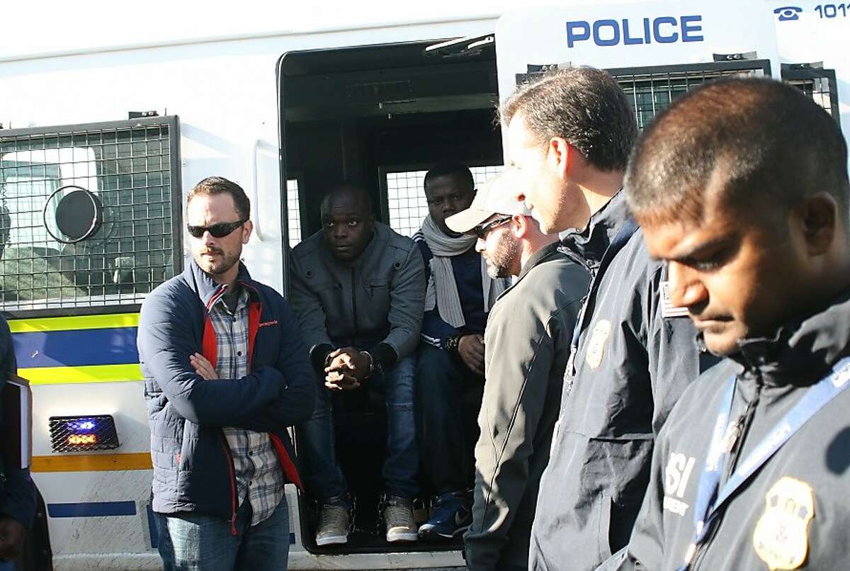 In a handout photo, members of the �Yahoo Boys,� a Nigerian criminal ring, are arrested by Homeland Security Investigations agents and the South African Police Service in Pretoria in 2014. Set up to defend the United States, the Homeland Security Department is increasingly going beyond American borders to fight foreign threats from abroad. (Immigration and Customs Enforcement, Homeland Security Investigations Pretoria via The New York Times) -- FOR EDITORIAL USE ONLY --