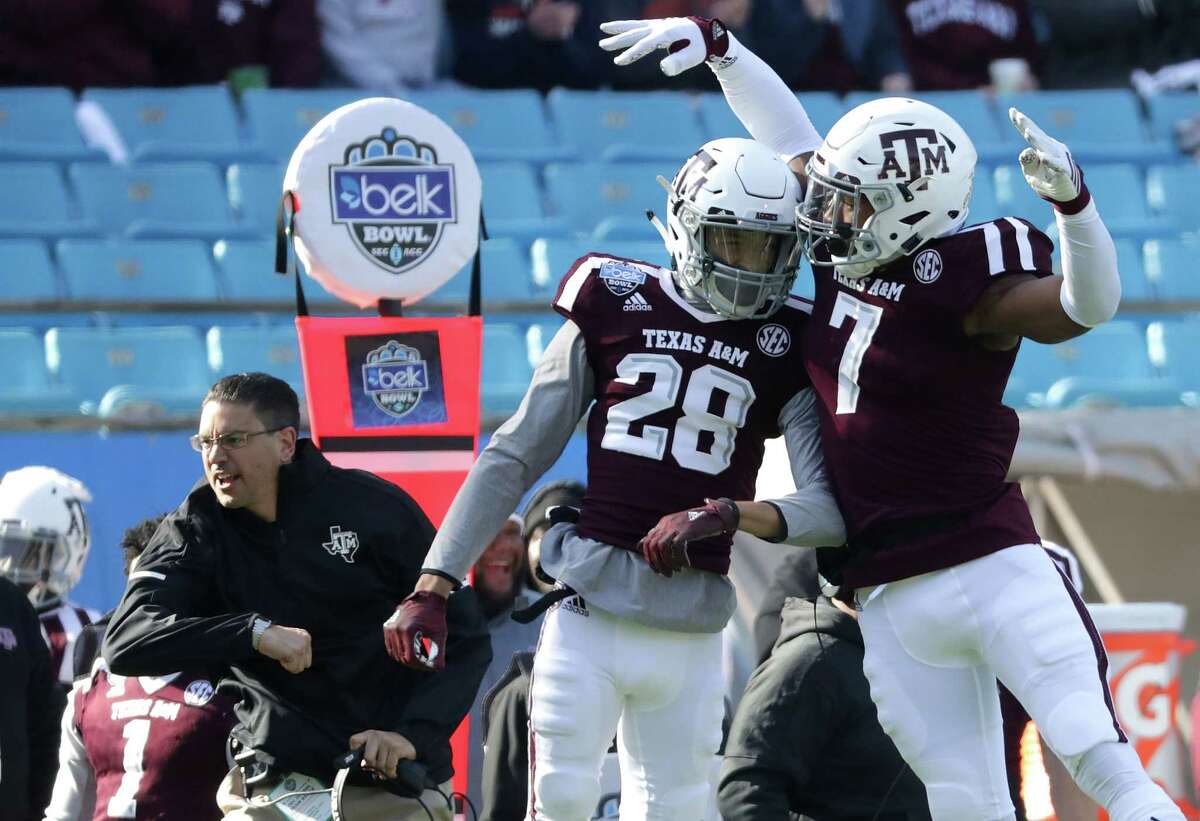 CHARLOTTE, NC - DECEMBER 29: Interim head coach Jeff Banks reacts with players Travon Fuller #28 and Buddy Johnson #7 of the Texas A&M Aggies after a play against the Wake Forest Demon Deacons during the Belk Bowl at Bank of America Stadium on December 29, 2017 in Charlotte, North Carolina.
