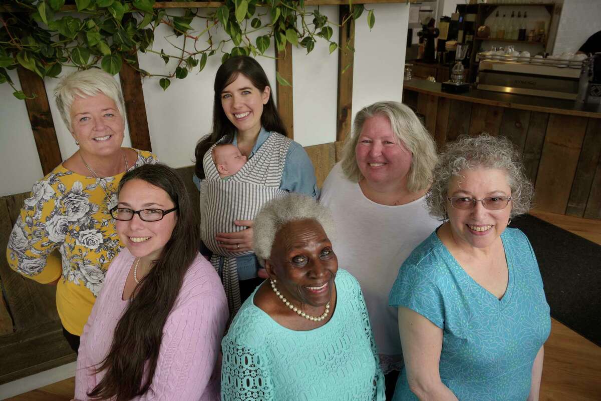 From left to right, Megan O'Toole, Danielle Sanzone, Caroline Corrigan with her son, Graham Watkins, Ada Kinsey, Mary Beth Clancy-Halayko, and Cecile Kowalski pose for a photo on Thursday, Sept. 28, 2017, at Stacks Espresso Bar in Albany, N.Y. (Paul Buckowski / Times Union)