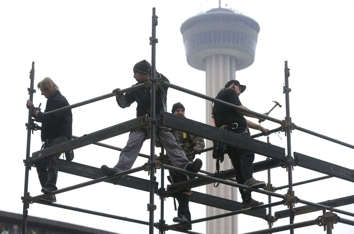 A crew works to erect a structure made of steel pipes Friday, Dec. 29, 2017, at HemisFair near the Henry B. Gonzalez Convention Center. Stages for musical performances, tents and other stuctures in the area just west of the Convention Center are being assembled for the upcoming New Year's Eve Celebration that will kick off San Antonio's 300th birthday celebration. The event is free and open to the public and opens at 4:00 p.m. . The event will feature interactive art, games, music and live theatrical performances. A wide array of food and drink options will be available.