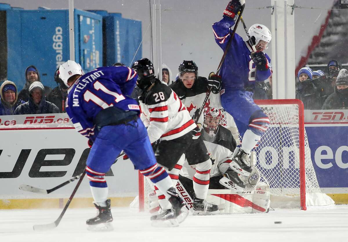 BUFFALO, NY - DECEMBER 29: Casey Mittelstadt #11 of United States takes a shot as Adam Fox #8 jumps to screen Carter Hart #31 of Canada during the IIHF World Junior Championship at New Era Field on December 29, 2017 in Buffalo, New York. The United States beat Canada 4-3. (Photo by Kevin Hoffman/Getty Images)