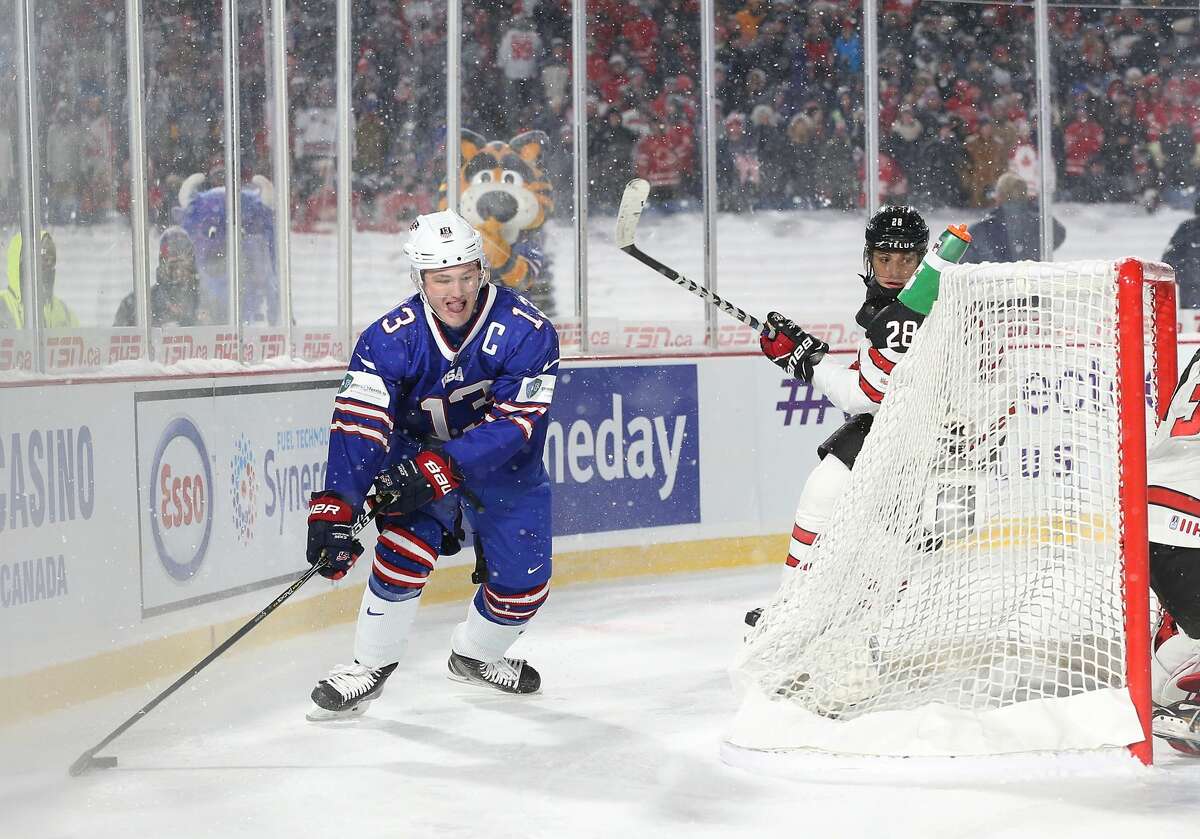 BUFFALO, NY - DECEMBER 29: Joey Anderson #13 of United States with the puck behind the net as Victor Mete #28 of Canada pursues during the IIHF World Junior Championship at New Era Field on December 29, 2017 in Buffalo, New York. The United States beat Canada 4-3. (Photo by Kevin Hoffman/Getty Images)