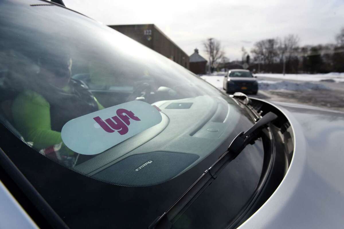 A Lyft sticker is shown in driver Christopher Sokol's car at the ride-hailing parking lot near Albany International Airport on Friday, Dec. 29, 2017, in Colonie, N.Y. (Will Waldron/Times Union archive)