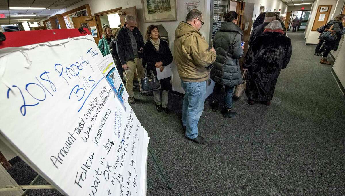 Homeowners line up to pay their property taxes to beat the New Year deadline for a tax right off at Town Hall on Friday, Dec 29, 2017, in Bethlehem, N.Y. (Skip Dickstein/ Times Union)