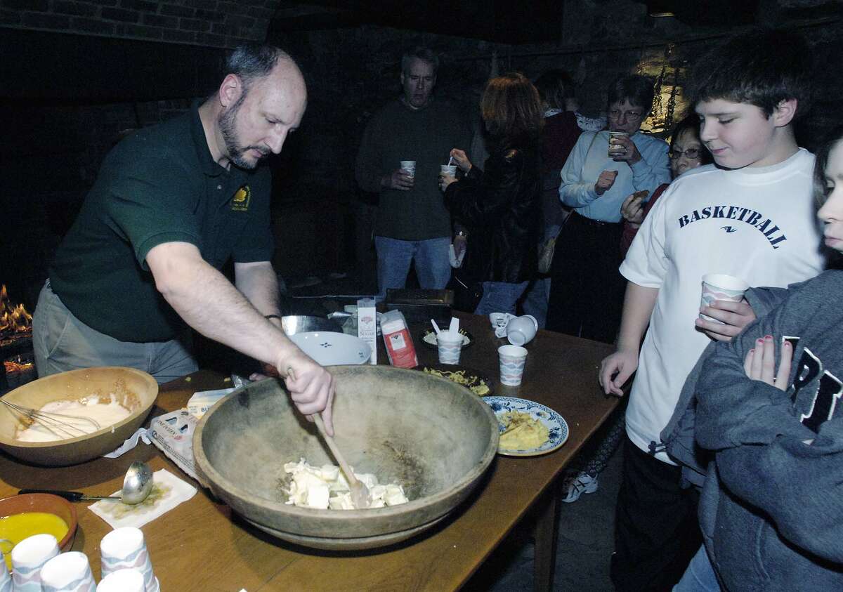 Times Union Photo by James Goolsby-Jan. 6 2007-(LEFT-Joe Gramaldi, volunteer for the Crailo State Historic Site. Makes a pound cake while heartside cooking. As part of the Annual Twelfth Night Celebration at the Crailo State Historic Site in Rensselaer.