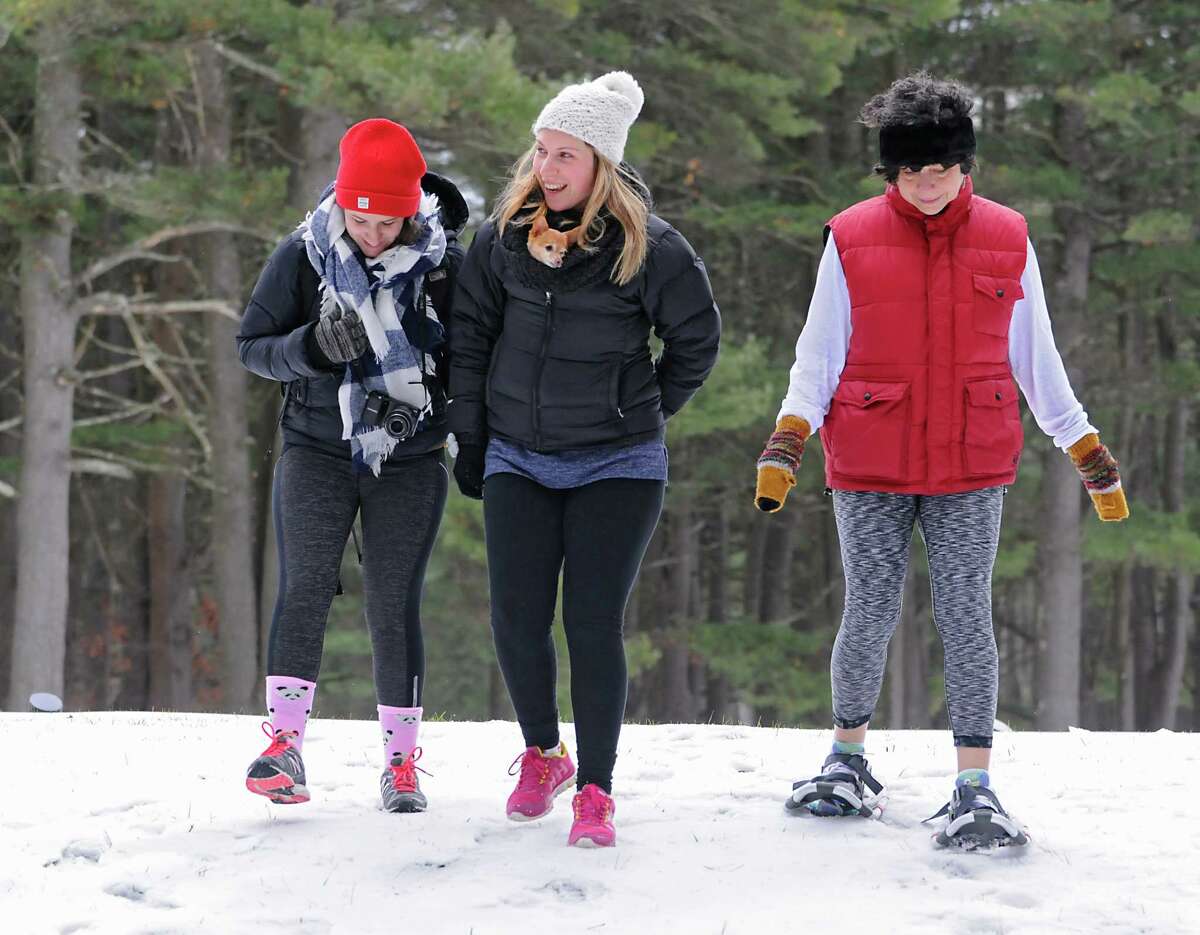 From left, Katherine Turro, Molly Turro with her dog Tinkerbell and Linda Scacco, all from West Hartford, Conn. participate in a first hike on New Year's Day at Saratoga Spa State Park on Friday, Jan. 1, 2016 in Saratoga Springs, N.Y. (Lori Van Buren / Times Union)