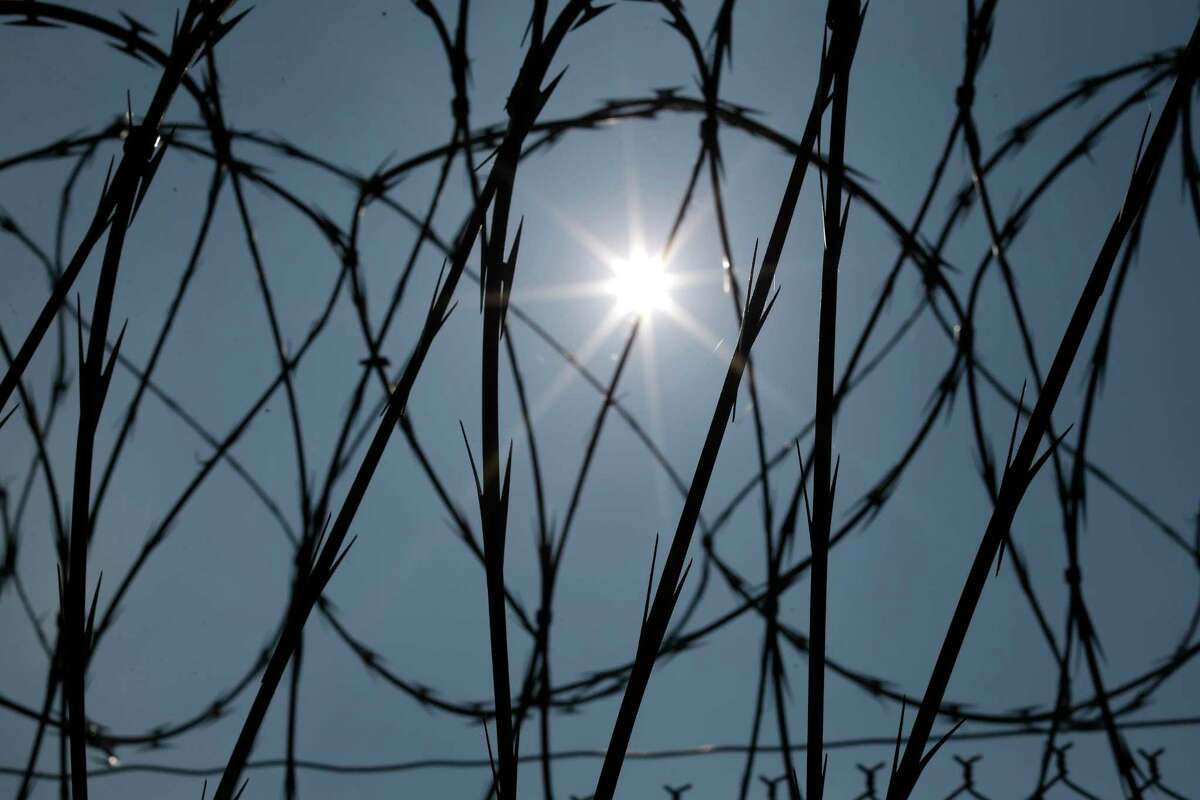 ADVANCE FOR RELEASE SUNDAY, DEC. 31, 2017 AND THEREAFTER -FILE - In this Saturday, April 26, 2014 file photo, the sun shines through concertina wire on a fence at the Louisiana State Penitentiary in Angola, La. Nearly two years after the January 2016 U.S. Supreme Court ruling that prison inmates who killed as teenagers are capable of change and may deserve eventual freedom, the question remains unresolved: Which ones should get a second chance? (AP Photo/Gerald Herbert)