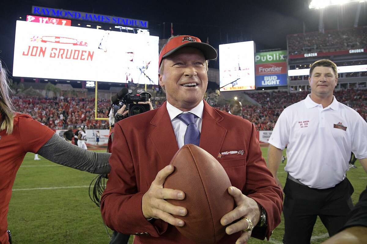 Former Tampa Bay Buccaneers head coach Jon Gruden, center, reacts after being inducted into the Buccaneers Ring of Honor during halftime of an NFL football game against the Atlanta Falcons Monday, Dec. 18, 2017, in Tampa, Fla. (AP Photo/Phelan M. Ebenhack)