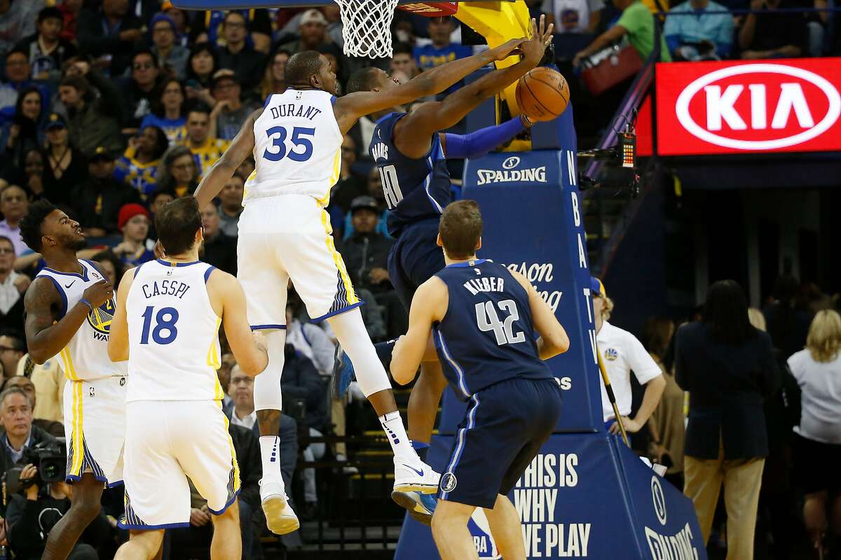 Kevin Durant #35 of the Golden State Warriors blocks a shot by Harrison Barnes #40 of the Dallas Mavericks during the second quarter of their NBA basketball game at Oracle Arena in Oakland, Calif. on Thursday, Dec. 14, 2017.