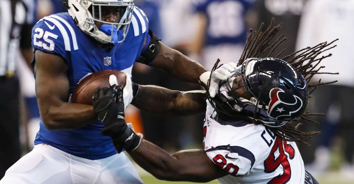 Indianapolis Colts running back Marlon Mack (25) breaks away from Houston Texans outside linebacker Jadeveon Clowney (90) during the third quarter of an NFL football game at Lucas Oil Stadium on Sunday, Dec. 31, 2017, in Indianapolis. ( Brett Coomer / Houston Chronicle )