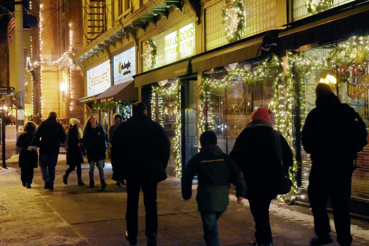 People are bundled up against the cold temperatures as they make their way along Broadway during Saratoga First Night on Sunday, Dec. 31, 2017, in Saratoga Springs, N.Y. (Paul Buckowski / Times Union)