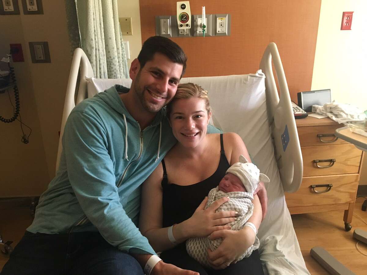 Harrison and Amelia Levy hold their daughter, Layla Rose, Monday at Yale New Haven Children’s Hospital. Layla Rose was born at 58 seconds past midnight, making her one of the first babies born in the United States in 2018.