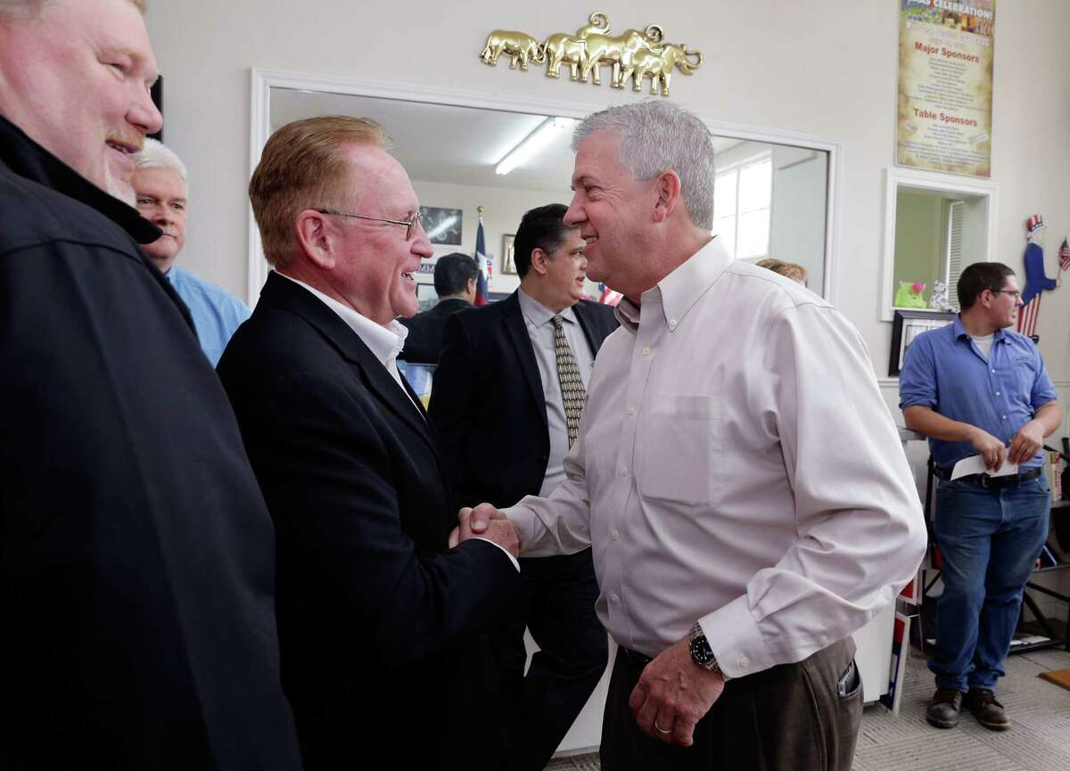Rep. Mark Keough and Judge Craig Doyal, both candidates for the same judge seat, shake hands before they draw numbers for ballot position at the Montgomery County Republican Party office in Conroe, TX, Dec. 21, 2017. (Michael Wyke / For the Chronicle)