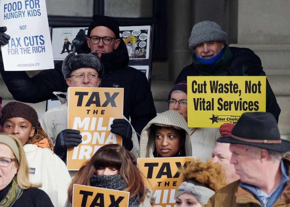 Progressive activists gather outside the Capitol calling for higher taxes on the wealthiest New Yorkers to help the needy