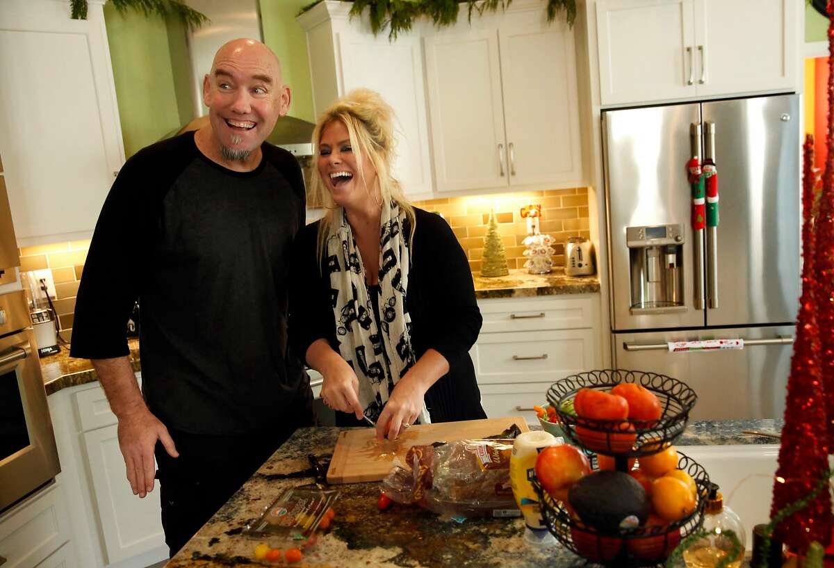 KNBR sports talk-show radio host Tom Tolbert with his wife Lorrie at their home in Alameda, Calif. on Monday December 4, 2017. Tolbert is still recovering from major heart surgery he had last August.