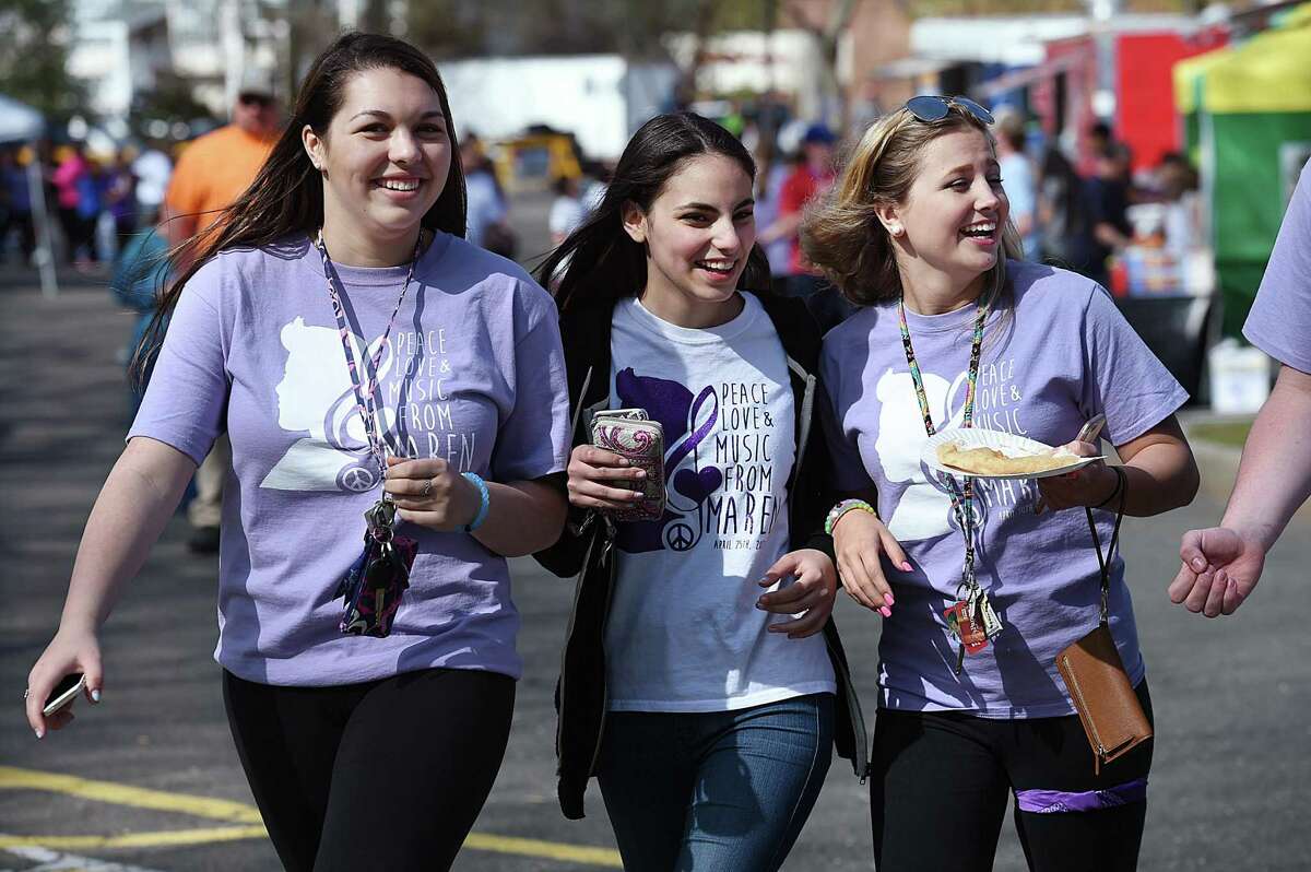 Jonathan Law juniors Lexi Fisk, 17, Basima Karzoun, 16, and Marissa Tollack, 16, walk through food truck area at the second annual Peace, Love, & Music from Maren at Jonathan Law High School, Saturday, April 30, 2016, in Milford. The event was a way to remember and celebrate the life of Maren Sanchez who was killed in the school's hallway hours before the prom April 25, 2014. (Catherine Avalone/New Haven Register)