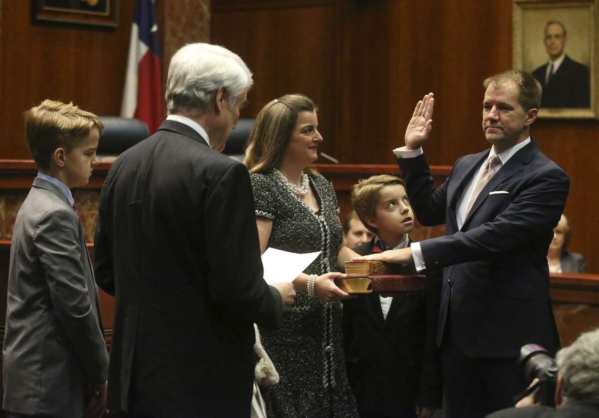 Chief Justice Nathan L. Hecht (left, facing away) administers the oath of office to Don R. Willett (right) on Tuesday at the Supreme Court of Texas in Austin. Willett, nominated by President Donald Trump and approved by the Senate to be a judge on the 5th U.S. Circuit Court of Appeals. Willett is accompanied by his family.
