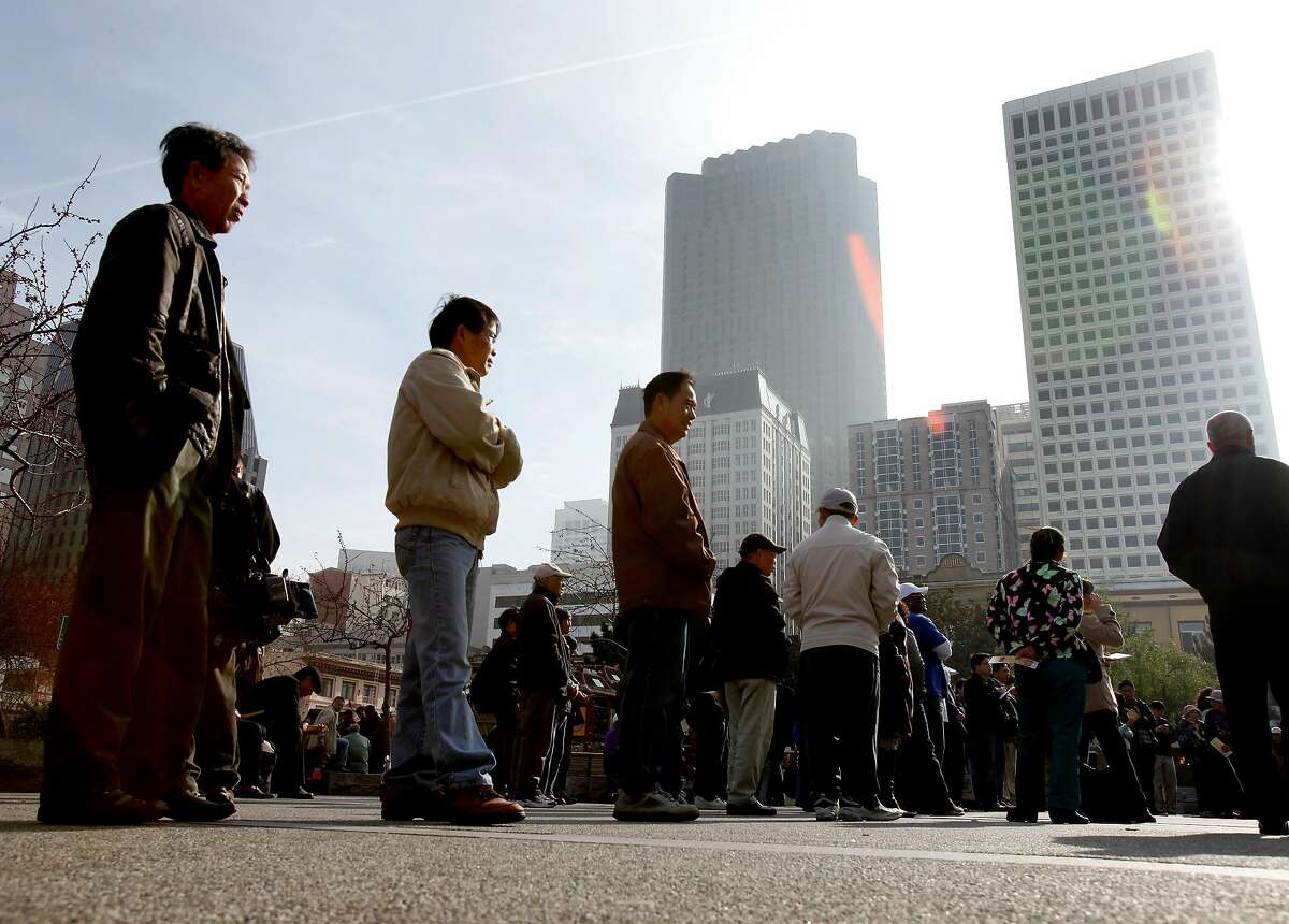 Residents of San Francisco's Chinatown line up to watch a demonstration for the 2010 census. The 2020 census has been plagued by underfunding and attempts to undercount minorities.