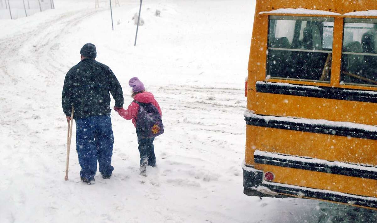 A 2003 snow storm took the Stamford school system by surprise, causing buses to be late and prompting an early dismissal. Here, William Marquet holds his daughter Rachel's hand as he brings the first-grader home early from Stark Elementary School.