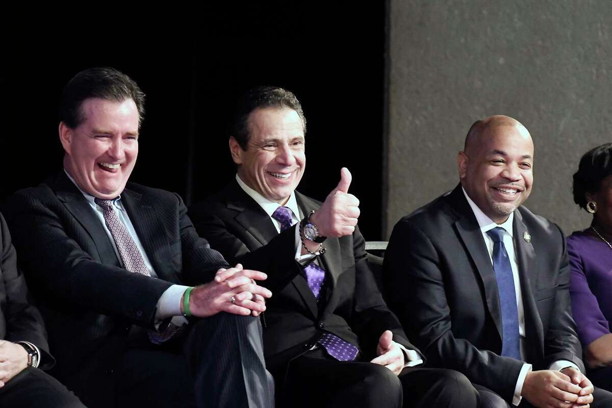New York Gov. Andrew Cuomo, center, is flanked by Senate Majority Leader John Flanagan, R-Smithtown, left, and Assembly Speaker Carl Heastie, D-Bronx, right, as he wits to deliver his State of the State address at the Empire State Plaza Convention Center on Wednesday, Jan. 3, 2018, in Albany, N.Y. (AP Photo/Hans Pennink)