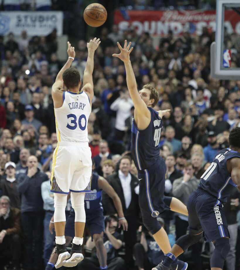 Golden State Warriors guard Stephen Curry (30) takes the last shot of the game against Dallas Mavericks forward Dirk Nowitzki (41) of Germany during the second half of an NBA basketball game in Dallas, Wednesday, Jan. 3, 2018. (AP Photo/LM Otero) Photo: LM Otero, Associated Press