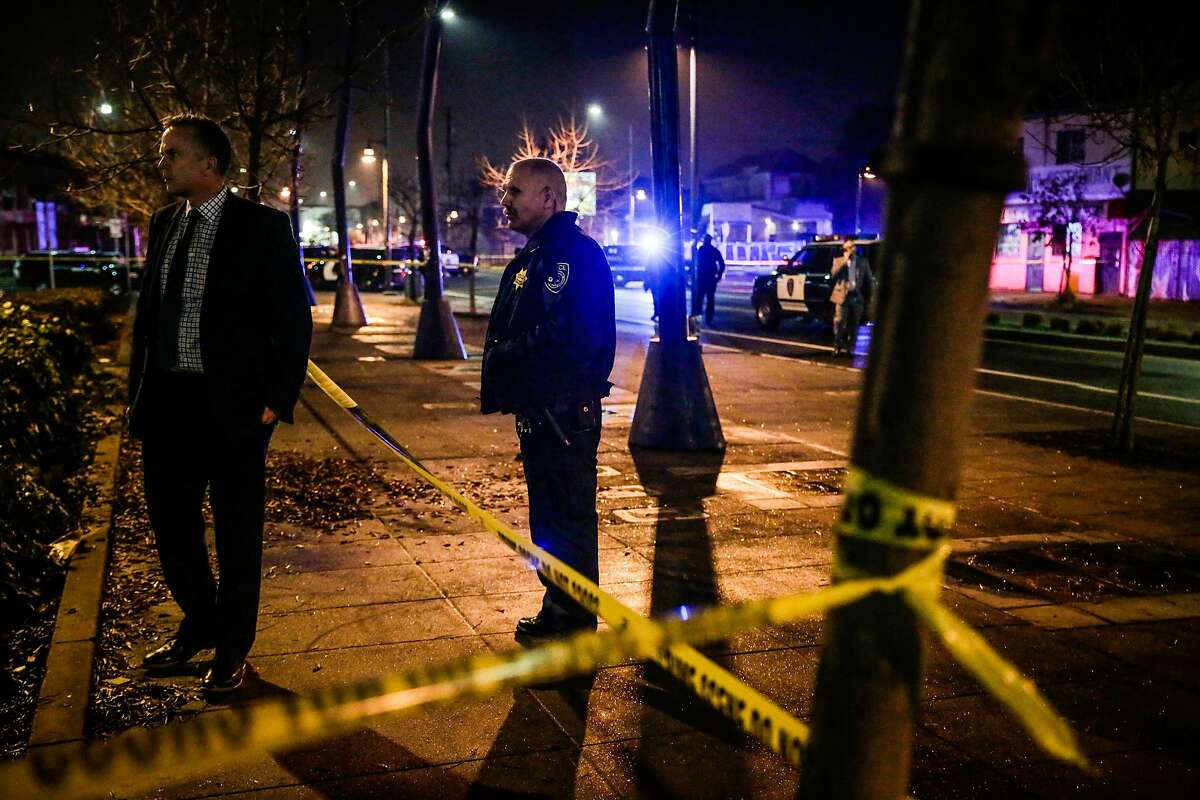 A police officer stands by after a shooting on 7th and Chester Streets outside the West Oakland Bart Station in Oakland, Calif., on Wednesday, Jan. 3, 2018.