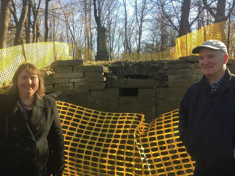 Susan Virgilio, left, with Robert Mullens, right, at the Slingerland family burial vault in Slingerlands in the town of Bethlehem on Dec. 6, 2017. The two Slingerland family members are part of a group trying to restore the vault but didn't know one another until a few months ago. Photo: Larry Rulison