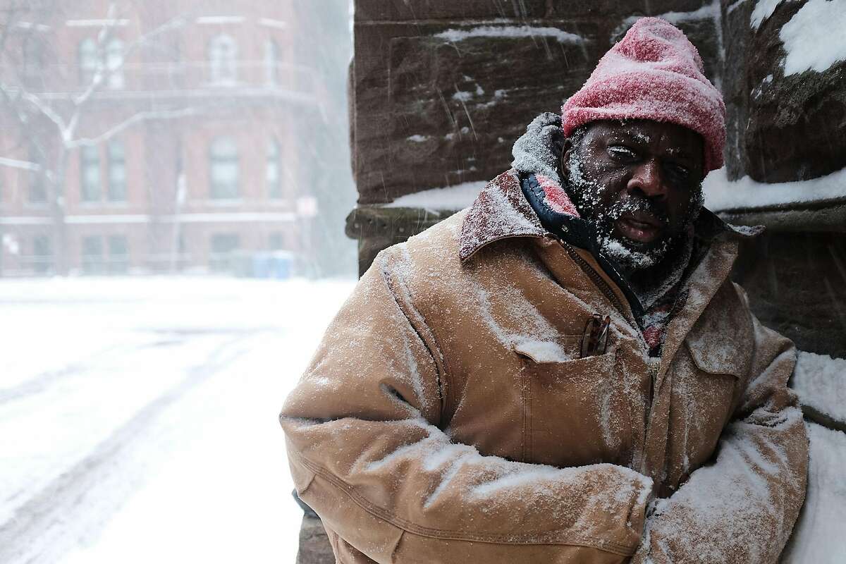 George, who is homeless, pauses in a church alcove, on the streets of Boston as snow falls from a massive winter storm on January 4, 2018 in Boston, Massachusetts. Schools and businesses throughout the Boston area are closed as the city is expecting over a foot of snow and blizzard like conditions throughout the day. (Photo by Spencer Platt/Getty Images)