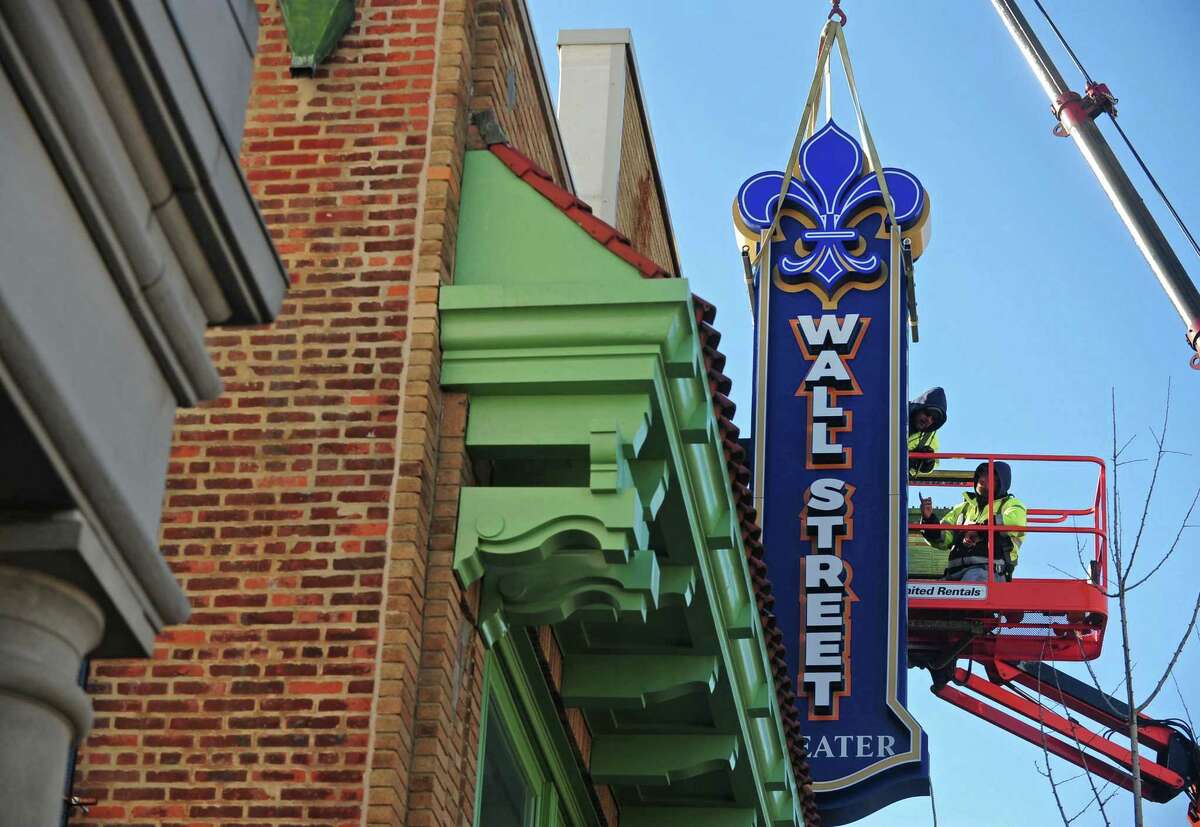 Workers with ABC Signs hang the new sign for the Wall Street Theater on Wall Street in Norwalk.The theater opened in May of this year and offers a variety of live entertainment.