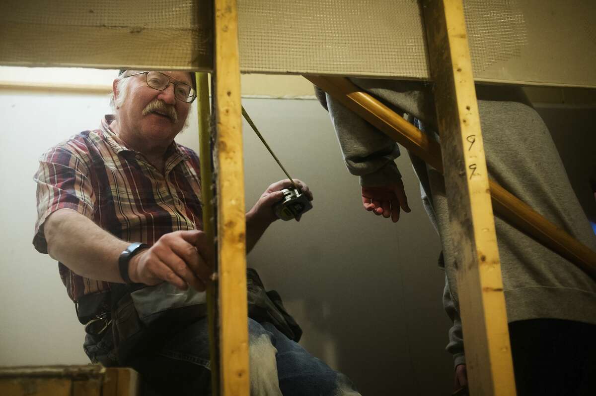 John Potts of St. Charles works to install drywall inside the home of Mike Lacusta and his family on Thursday, Dec. 28, 2017 in Midland. Volunteers from Chesaning United Methodist Church, working through the United Methodist Committee on Relief, helped to repair the Lacustas' basement, which was damaged by flooding in June. (Katy Kildee/kkildee@mdn.net)