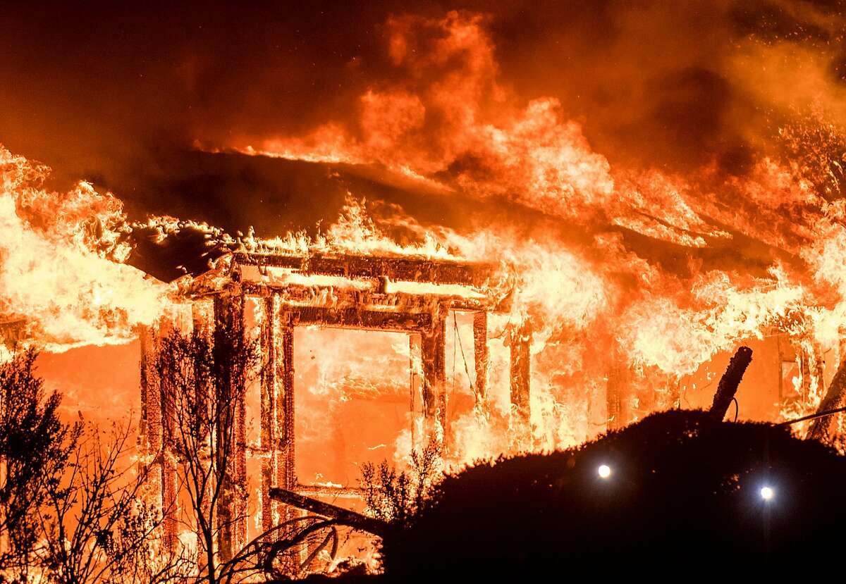 Flame consume a structure on Partrick Rd. in Napa, Calif., on Monday, Oct. 9, 2017.