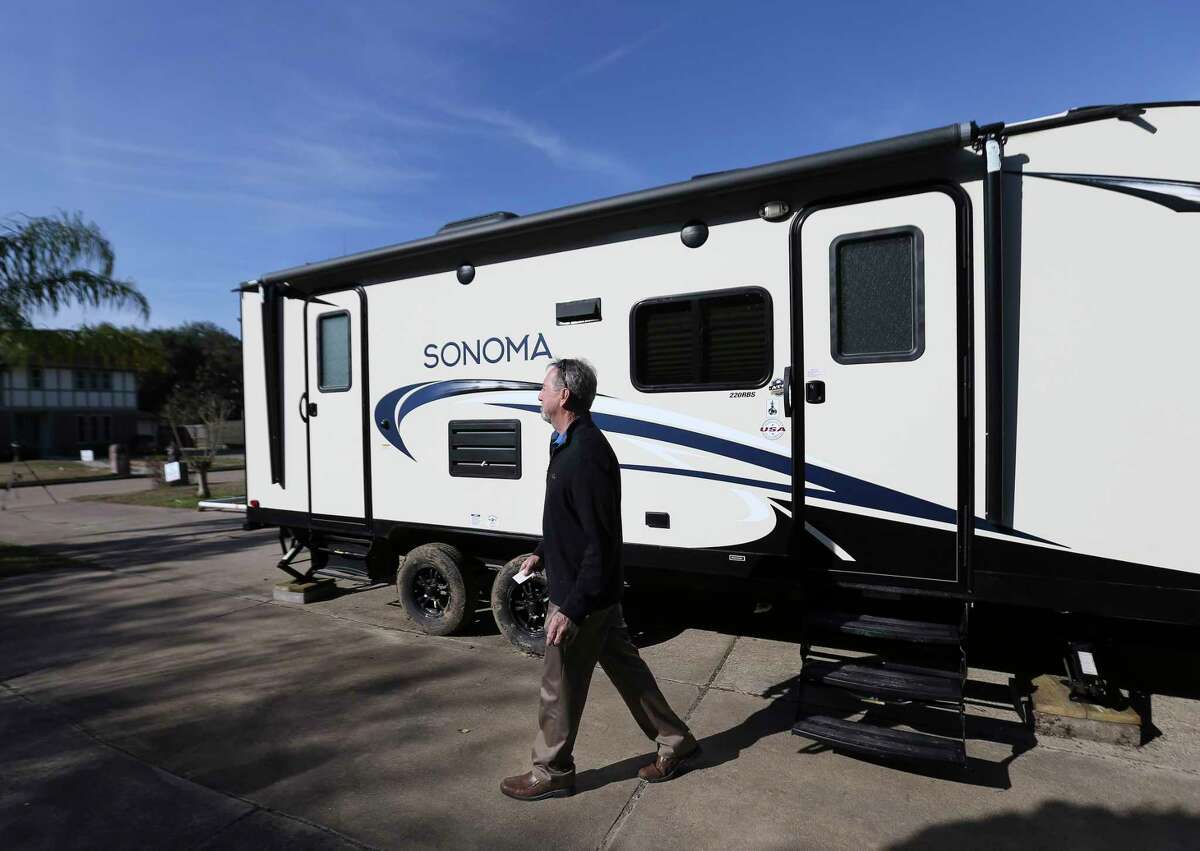Hurricane Harvey flooded homeowner Scott Short, 66, walks out of his 8' x 20' FEMA RV in his driveway on Thursday, Jan. 4, 2018, in League City. Short has been living in the RV for about two weeks.