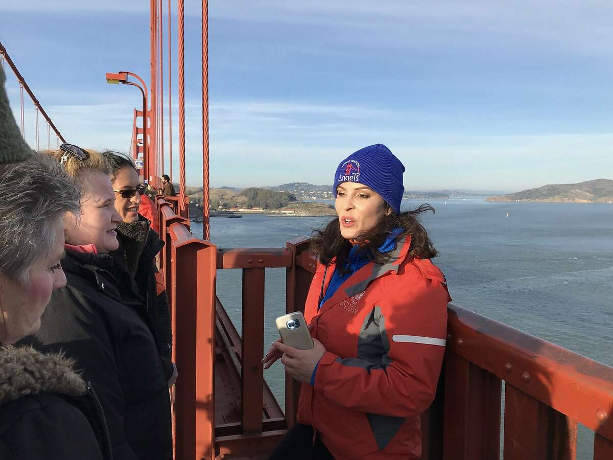 Bridgewatch founder Mia Munayer with volunteers on the Golden Gate Bridge.