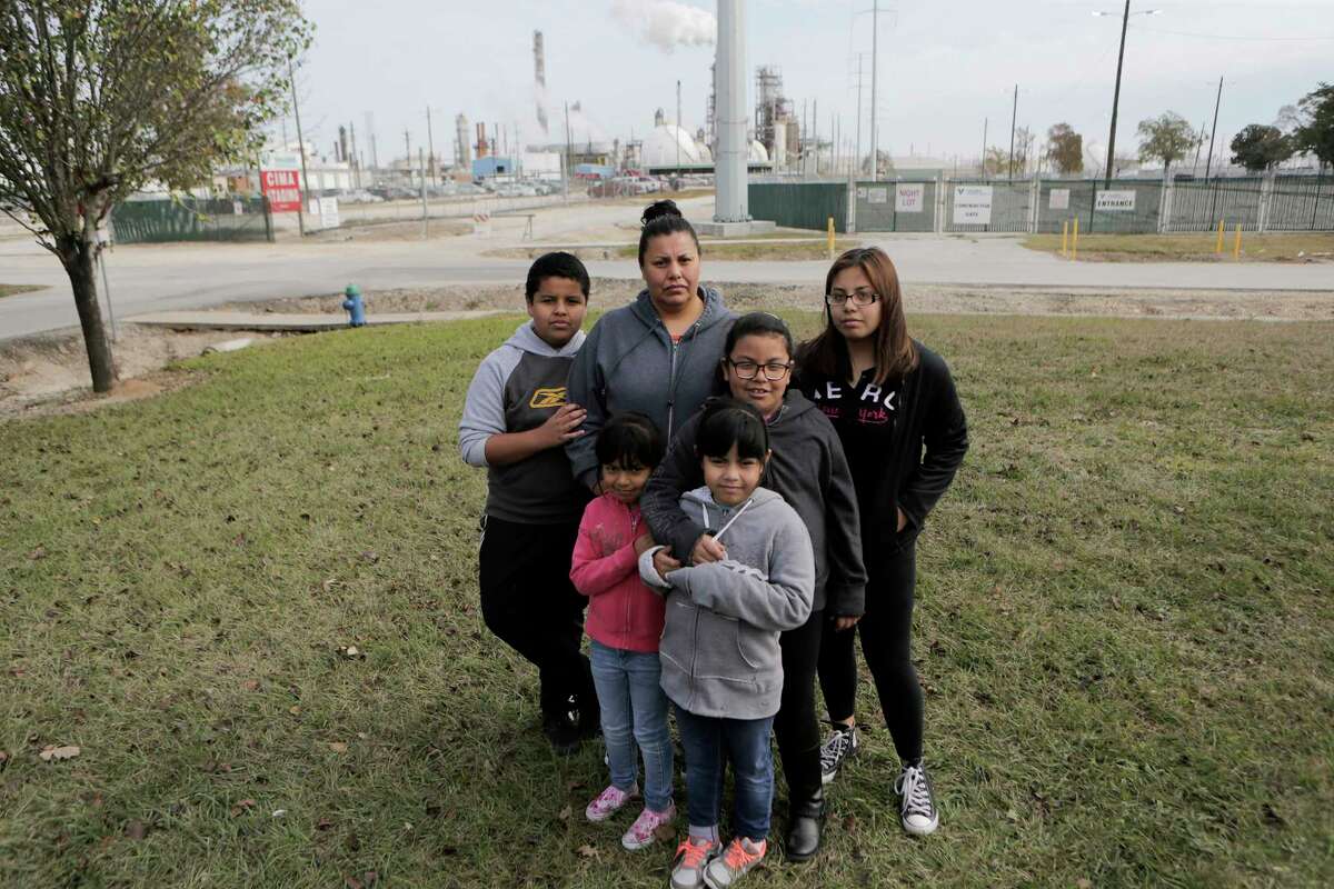 Sarahi Touar stands in her front yard with her children Abraham, 11, (from left), Marisa, 5, Marion, 7, Camila, 8, and Dalila, 16 in their Manchester neighborhood on Saturday, Dec. 16, 2017, in Houston. ( Elizabeth Conley / Houston Chronicle )