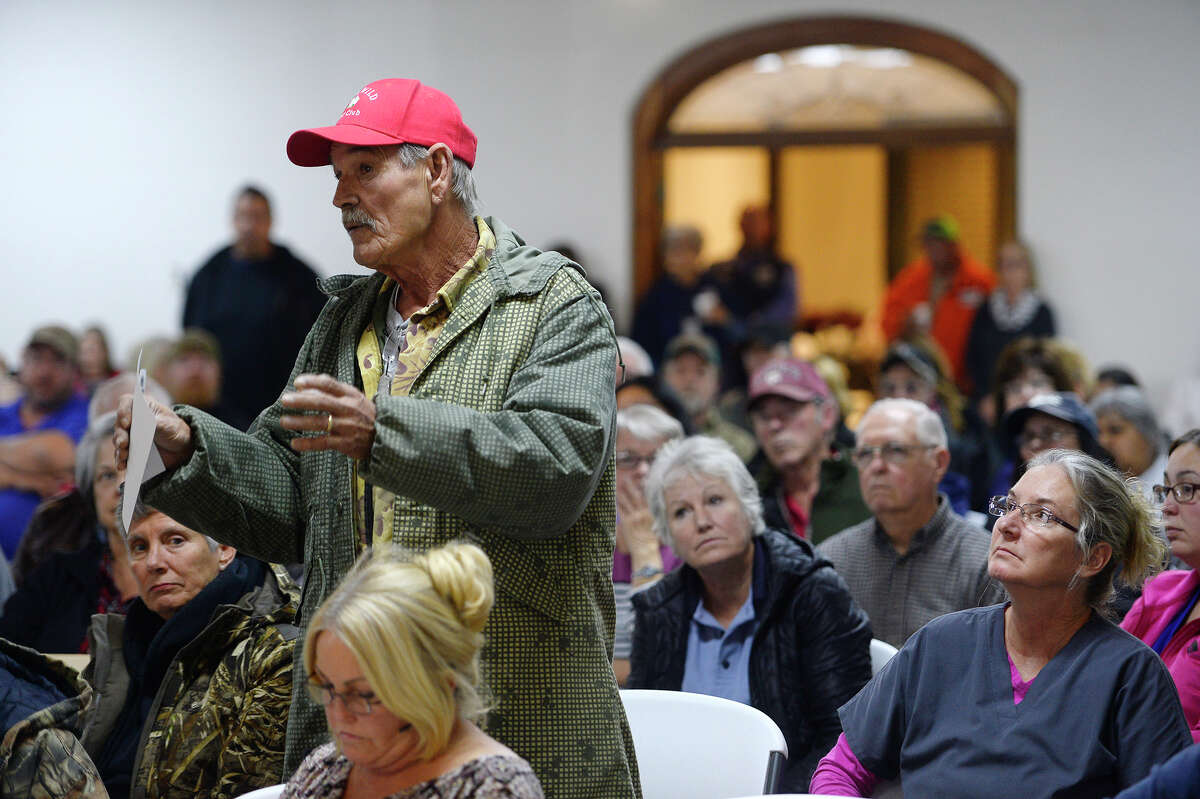 Don Carmane asks a question during a public forum for flood victims at Rose City Baptist Church on Thursday evening. Carmane said he has flood insurance but has been offered less than the repairs will cost. Photo taken Thursday 1/4/18 Ryan Pelham/The Enterprise