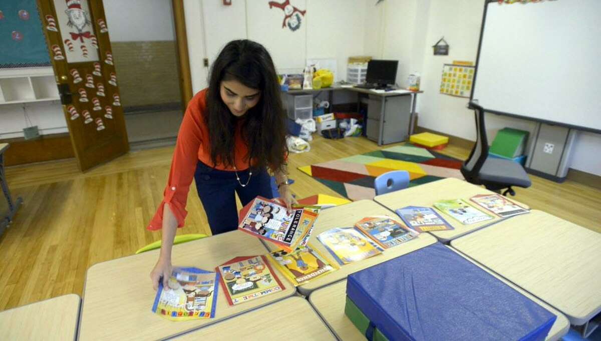 Amina Toor, a first year, first grade teacher at New School in Stamford, sets up her classroom on Wednesday, Aug. 31, 2016. Toor grew up in Stamford and graduated from the Stamford Public School system.